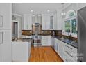 Bright kitchen with granite countertops, stainless steel appliances, and custom cabinetry at 15724 Eagleview Dr, Charlotte, NC 28278