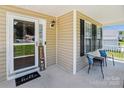 Inviting front porch with seating, featuring a decorative welcome mat, door, and ample natural light at 2040 Brantley Creek Dr, Kannapolis, NC 28083