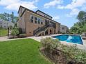 A brick home with a screened-in porch over looking a crystal clear pool, perfect for relaxing at 217 Turtleback Rdg, Weddington, NC 28104