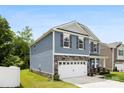 Attractive two-story home featuring stone accents, a two-car garage, and a well-maintained lawn at 3734 Stanley Creek Dr, Mount Holly, NC 28120