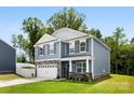 Beautiful two-story home featuring a well-kept lawn, stone accents, and a welcoming front entrance at 3734 Stanley Creek Dr, Mount Holly, NC 28120