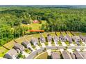 Picturesque aerial view of a residential neighborhood surrounded by lush green forest and landscaping at 3855 Tersk Dr, Midland, NC 28107