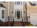 View of front porch with brick steps, decorative iron railings, and sidelights framing the front door at 4519 Rock Stream Dr, Charlotte, NC 28269