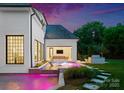 The backyard features a modern pool with a built-in hot tub, and an outdoor seating area at 4714 Ockley Manor Ln, Charlotte, NC 28226