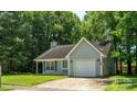 Attractive single-story home with attached garage, neat landscaping, and traditional architectural details at 5019 Poplar Glen Dr, Matthews, NC 28104