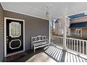 Inviting covered front porch with a white bench, decorative light fixture, and view of the neighborhood at 6017 Millbury Ct, Charlotte, NC 28211