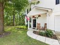Charming white home featuring a well-kept lawn and inviting front porch with rocking chairs at 705 Torrey Pines Ln, Fort Mill, SC 29715