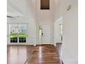 Open foyer with hardwood floors, a front door, and ample natural light at 7309 Rock Hampton Ct, Harrisburg, NC 28075
