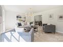 Open-concept living room boasts modern decor, neutral color palette, hardwood floors, and abundant light, creating an airy atmosphere at 811 Ashmeade Rd, Charlotte, NC 28211
