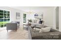 Bright living room with neutral tones, stylish furniture, large windows, and a modern chandelier, creating an inviting space at 811 Ashmeade Rd, Charlotte, NC 28211