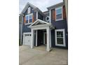 New construction home with blue siding, white trim, covered entrance and a one car garage at 8231 Annsborough Nw Dr, Concord, NC 28027