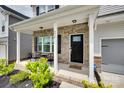 Inviting covered front porch with brick accents and black chairs creates a cozy entryway at 972 Von Buren Blvd # 242, Rock Hill, SC 29730