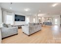 Bright living room with wood floors, large windows, and modern decor for a comfortable space at 972 Von Buren Blvd # 242, Rock Hill, SC 29730