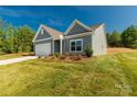Well-kept single-story home with a manicured lawn and a two-car garage in a serene setting at 10180 Lakeshore Dr, Lancaster, SC 29720