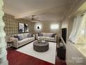 Comfortable living room with stylish sofas, elegant decor, and a modern ceiling fan for relaxed living at 1107 Crestfield Dr, Lancaster, SC 29720