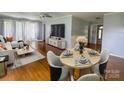 Open-concept living area with hardwood floors, a dining nook, and modern furnishings perfect for entertaining at 1107 Crestfield Dr, Lancaster, SC 29720