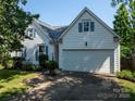 Charming home featuring white siding, blue shutters, and a two-car garage at 11911 Brownestone View Dr, Charlotte, NC 28269