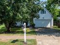 Charming home featuring white siding, blue shutters, and a two-car garage at 11911 Brownestone View Dr, Charlotte, NC 28269