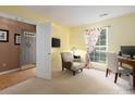 Bright home office with a computer setup, cozy chair, and ample natural light at 11911 Brownestone View Dr, Charlotte, NC 28269
