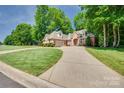 Traditional brick home featuring a two-car garage and a manicured lawn at 125 Highland Forest Dr, Clover, SC 29710