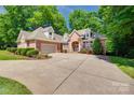 Traditional brick home featuring a two-car garage and a manicured lawn at 125 Highland Forest Dr, Clover, SC 29710