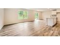Spacious living room featuring hardwood floors, abundant natural light, and seamless access to the outdoors at 136 Dorian Pl, Troutman, NC 28166