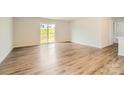 Bright and airy living room features sliding glass doors to the backyard and stylish, modern flooring at 140 Astor St, Troutman, NC 28166