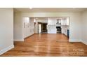 Spacious living room with open layout, hardwood floors, and a clear view into the modern kitchen at 1513 Greenview Pl, Charlotte, NC 28208