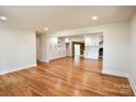 Bright open-concept living room featuring hardwood floors and seamless flow to the kitchen at 1513 Greenview Pl, Charlotte, NC 28208
