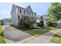 Two-story home with long driveway leading to detached garage, and manicured front yard at 17327 Summers Walk Blvd, Davidson, NC 28036