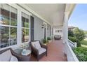 Inviting front porch with comfortable seating, plants and view of front yard at 17327 Summers Walk Blvd, Davidson, NC 28036