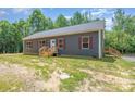 Inviting single-story home featuring a side entrance and new construction, nestled in a wooded landscape at 1870 Hwy 49 None, New London, NC 28127