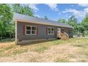 Single-story home featuring a inviting front entrance and new construction, nestled in a wooded landscape at 1870 Hwy 49 None, New London, NC 28127