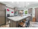 A well-appointed kitchen features an island with seating, stainless appliances, and wood cabinetry at 1870 Hwy 49 None, New London, NC 28127