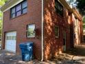An external view of a garage attached to the house with a waste container next to it at 209 8Th Nw Ave, Hickory, NC 28601