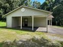 Attached carport with a doorway and gravel extending to a yard at 227 James Rd, Taylorsville, NC 28681