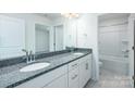 Well-lit bathroom featuring double sinks with granite countertops and a separate toilet room at 259 Miramar Dr, York, SC 29745
