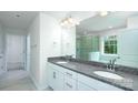 Bright bathroom featuring double sinks with granite countertops and a glass-enclosed shower at 259 Miramar Dr, York, SC 29745