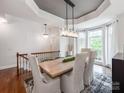 Bright dining room boasts modern chandelier, tray ceiling, and a large window with tons of natural light at 3036 Luke Crossing Dr, Charlotte, NC 28226