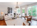 Spacious living room filled with natural light has plush seating, elegant decor, and access to the outdoors at 3036 Luke Crossing Dr, Charlotte, NC 28226