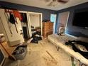 Bedroom with blue walls, laminate flooring, closet and some furnishings at 3396 Farm Lake Sw Dr, Concord, NC 28027