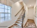 Staircase with wood treads and a window, creating a bright and open space at 4148 Skyboat Cir, Fort Mill, SC 29715