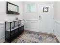 Bright foyer with a decorative mirror, a console table, a stylish rug, and a white front door at 4177 Steel Way, Sherrills Ford, NC 28673