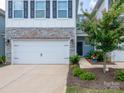 Charming townhome featuring stone accents, a two-car garage, and a small tree in the front yard at 4177 Steel Way, Sherrills Ford, NC 28673