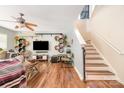 Inviting living room with modern decor, ceiling fan, hardwood floors, and a staircase at 4312 Mary Point Rd, Monroe, NC 28110