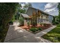 Charming home with a detached garage, a well-manicured lawn, and beautiful landscaping at 5014 Quail Canyon Dr, Charlotte, NC 28226