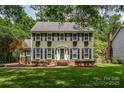 Charming two-story home featuring shutters, window box planters, and a well-manicured front lawn at 5014 Quail Canyon Dr, Charlotte, NC 28226