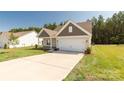 A single Gathering home with neutral siding, well-manicured lawn, and a two-car garage at 5208 Admirals Lndg, Lancaster, SC 29720