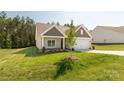 Inviting exterior view of a single Gathering home with a well manicured lawn and 2-car garage at 5208 Admirals Lndg, Lancaster, SC 29720