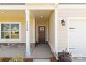 Inviting front porch with stone accents, a stylish front door, and exterior lighting at 5208 Admirals Lndg, Lancaster, SC 29720